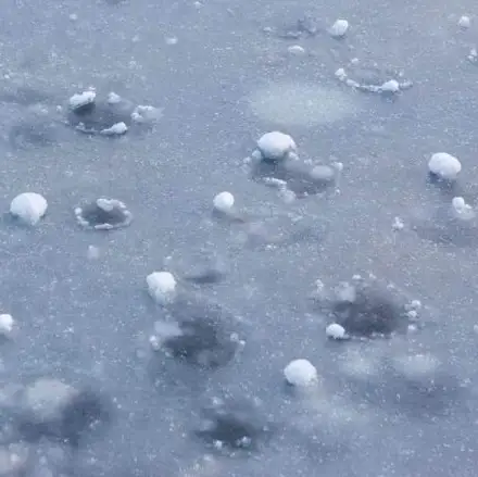Close-up of hail damage on a car surface