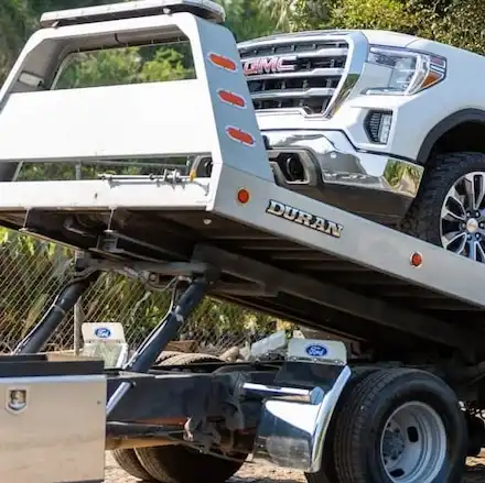 Tow truck lifting a vehicle in Lewisville for emergency towing